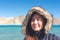 Portrait image of a beautiful Asian woman standing in front of Pangong lake