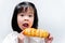 Portrait image. Child having fun eating sweets. Sweet bread is eaten as a snack.