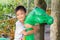 Portrait image of kid 5 years old. Happy Asian child boy playing with dinosaur toy at the playground.