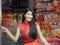 Portrait image pretty women are wearing red Cheongsam dress, happy smile while traveling in the night market