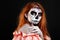 Portrait image of redhead woman, who is ready for the Halloween.