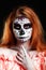 Portrait image of redhead woman, who is ready for the Halloween.