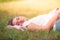 Portrait image of Young women sleeping on the grass in the park at sunset. Concept romantic and love. Warm tone