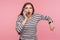 Portrait of impatient woman in striped sweatshirt talking on mobile phone and looking with shocked angry expression