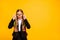 Portrait of impressed child touch specs have bag backpack rucksack isolated over yellow background