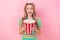 Portrait of impressed ecstatic girl with tails dressed colorful suit hands hold popcorn at cinema isolated on pink color