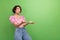 Portrait of impressed girl with short haircut wear stylish blouse look empty space catching object isolated on green