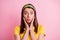 Portrait of impressed pretty brunette girl hands face blow kiss wear yellow cloth isolated on pastel pink color