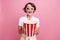 Portrait of impressed woman with short hair wear stylish blouse in 3d glasses hold pop corn at cinema isolated on pink