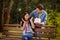 Portrait of impressed woman sitting on bench screaming wow omg look at giftbox given held by her spouse wearing denim