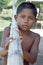 Portrait Indian boy trudging with bamboo pole