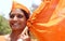 Portrait of an Indian Hindu woman waving saffron flag