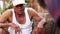 Portrait of Indian man with sports hat talking to his fellow workers.