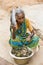 Portrait of an Indian old senior poor very thin woman with saree, selling fish