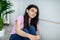 Portrait of Indian teen girl feeling upset and depressed, looking at camera, sitting near wall at home