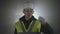 Portrait industrial engineers in hard hat on a black background in the spotlight.