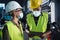 Portrait of industrial inspectors with face masks doing a general check up indoors at metal workshop, coronavirus