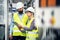 A portrait of an industrial man and woman engineer with tablet in a factory, talking.