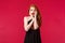 Portrait of insecure and shocked, embarrassed worried redhead woman in makeup and black luxurious dress feel panic of