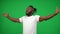 Portrait of inspired excited African American sportsman gesturing victory on green screen looking away. Happy successful