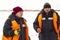 Portrait of installers in orange vests on the ice of the lake