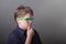Portrait of intelligent pensive kid with green glasses