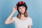 Portrait of interested inspired lady wear motorcycle helmet look blank space on blue background