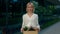 Portrait jobless woman who has just been released and standing near the business centre, holding a box containing work