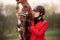 Portrait Jockey woman rider with brown horse, concept advertising equestrian club school