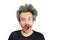 Portrait of jocular aging man with grey long hair sticking his tongue out in Einstein manner.  on background