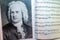 A portrait of Johann Sebastian Bach on the opened sheet music. Interior of musical room. Famous   people and their works.