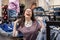 Portrait of joyful Caucasian smiling woman enjoying sale in clothing store. Concept of black friday