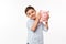 Portrait of a joyful cute little kid holding piggy bank