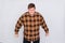 Portrait of a joyful fat man in a plaid shirt isolated on a white background. Concept of luck, success
