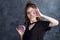 Portrait of joyful girl covering her eyes with donuts on black background. Attractive girl holding fresh donuts and having fun