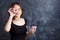 Portrait of joyful girl covering her eyes with donuts on black background. Attractive girl holding fresh donuts and having fun