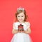 Portrait of joyful little girl with cake celebrating her birthday