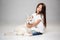 Portrait of a joyful little girl having fun with siberian husky puppy on the floor at studio