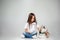 Portrait of a joyful little girl having fun with siberian husky puppy on the floor at studio