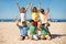 Portrait of joyful preteen boy friends on beach