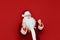 Portrait of Joyful Santa Claus rejoices in victory over red background. Santa is happy, yelling and actively gesturing with joy.
