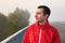 Portrait of a joyful smiling brunette man on a bridge on a foggy morning