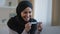 Portrait joyful surprised girl in hijab holding pregnancy test sit in living room excited with positive result beautiful