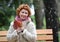 Portrait of the joyful woman of average years with autumn maple leaves in hands