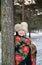 Portrait of the joyful woman of average years in the winter pine wood
