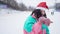 Portrait of joyful woman in Christmas hat playing snowballs at ski resort. Happy Caucasian lady having fun resting in