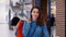 Portrait of joyful woman with full shopping bags