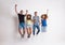 Portrait of joyful young group of friends jumping in a studio.