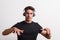 Portrait of a joyful young hispanic man with headphones in a studio. Copy space.