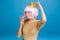 Portrait joyful young woman with pink haircut drinking champagne with closed on blue background. Brightful makeup with